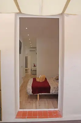 a view of a bedroom with a bed through a mirror at Hostal Gràcia in Barcelona