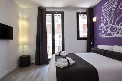 a hotel room with a bed with towels on it at Habitat Apartments ADN in Barcelona