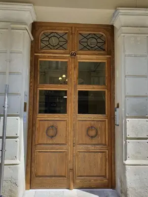 a wooden door with windows in a house at Casa Balmes in Barcelona
