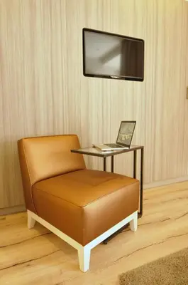 a chair with a laptop on a table with a tv at Casa Balmes in Barcelona