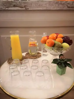 a table with glasses and a bowl of fruit and juice at Casa Balmes in Barcelona