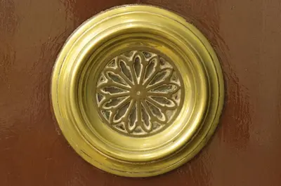 a gold frisbee hanging on a wall at Casa Balmes in Barcelona