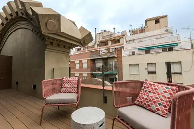 a balcony with two chairs and a couch on a building at CATERINA Editorial in Barcelona