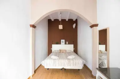 a bedroom with a bed in a white room at Consell Cent Apartment II 3 domitorios Eixample in Barcelona