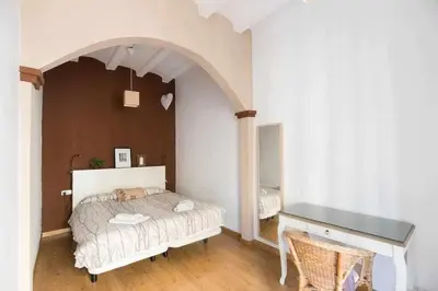 a bedroom with a bed and a desk at Consell Cent Apartment II 3 domitorios Eixample in Barcelona