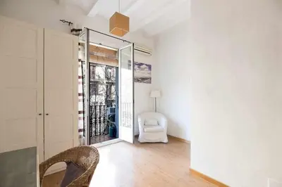 a white room with a chair and a window at Consell Cent Apartment II 3 domitorios Eixample in Barcelona
