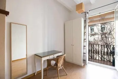 a room with a desk and a mirror and a window at Consell Cent Apartment II 3 domitorios Eixample in Barcelona