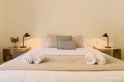 a bedroom with a bed with three towels on it at Sagrada Familia 360 in Barcelona