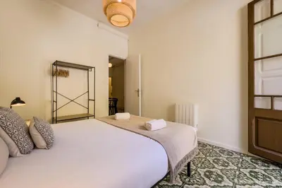 a bedroom with a large white bed and a window at Sagrada Familia 360 in Barcelona