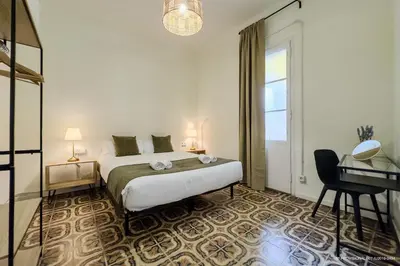 a bedroom with a bed and a desk and a window at Sagrada Familia 360 in Barcelona