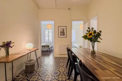 a dining room with a table and flowers on it at Sagrada Familia 360 in Barcelona