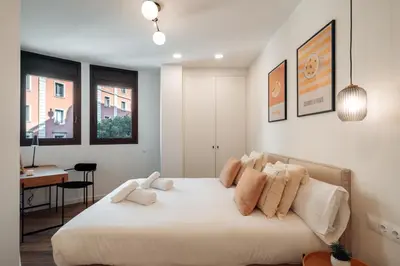 a bedroom with a large white bed with pillows at CATERINA Liceu in Barcelona