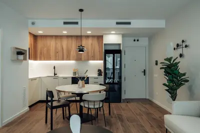 a kitchen and dining room with a table and chairs at CATERINA Liceu in Barcelona