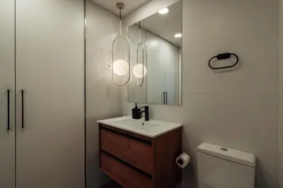 a bathroom with a sink and a mirror and a toilet at CATERINA Liceu in Barcelona
