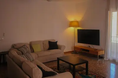 a living room with a couch and a flat screen tv at Piso superior tranquilo terraza y vistas A 45 min de Barcelona in Cunit