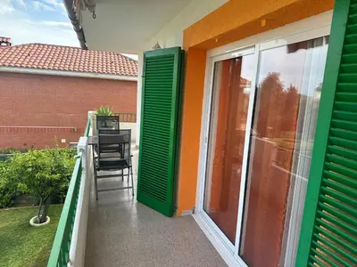 a balcony with green shutters on a house at Piso superior tranquilo terraza y vistas A 45 min de Barcelona in Cunit