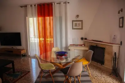 a living room with a glass table and chairs at Piso superior tranquilo terraza y vistas A 45 min de Barcelona in Cunit