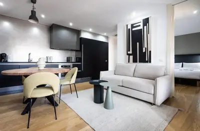 a kitchen and living room with a table and a couch at Stay U-nique Apartments Pau Claris II in Barcelona