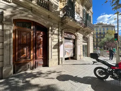 a motorcycle parked on a sidewalk in front of a building at Stay U-nique Apartments Pau Claris II in Barcelona