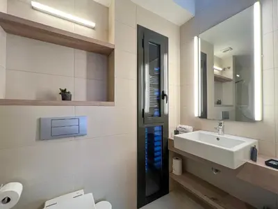 a bathroom with a sink and a mirror at Stay U-nique Apartments Pau Claris II in Barcelona