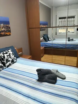 a bedroom with a bed with a towel on it at Room in shared appartment close to Camp Nou in Hospitalet de Llobregat