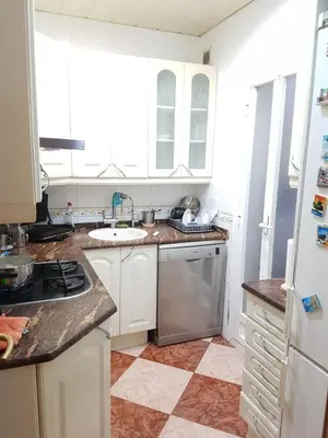 a kitchen with white cabinets and a sink at Room in shared appartment close to Camp Nou in Hospitalet de Llobregat