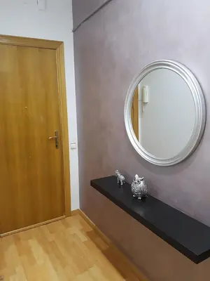 a mirror on a wall next to a black counter at Room in shared appartment close to Camp Nou in Hospitalet de Llobregat