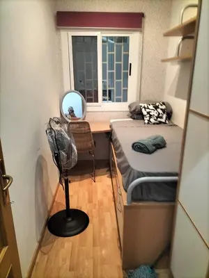 a small room with two beds and a mirror at Room in shared appartment close to Camp Nou in Hospitalet de Llobregat