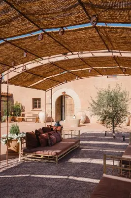 a couch sitting in the middle of a patio at Hotel-Masia Can Farrés in El Bruc