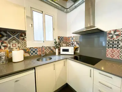 a kitchen with a sink and a microwave at Boutique Lepant in Barcelona