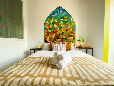 a bedroom with a large bed with towels on it at Boutique Lepant in Barcelona