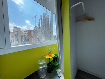 a room with a window and a table with a vase on it at Boutique Lepant in Barcelona