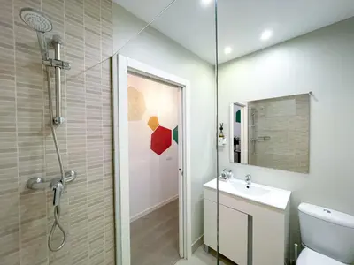 a bathroom with a shower and a toilet and a sink at Boutique Lepant in Barcelona