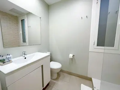 a bathroom with a sink and a toilet and a mirror at Boutique Lepant in Barcelona