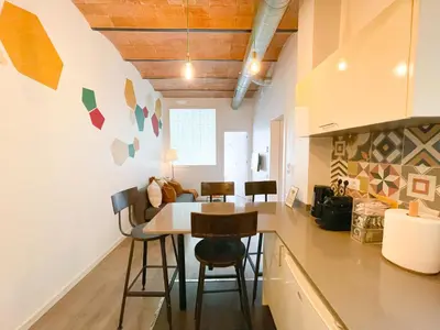 a kitchen and dining room with a table and chairs at Boutique Lepant in Barcelona