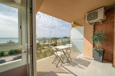 a balcony with a table and a view of the ocean at HomeHolidaysRentals Noelani- Costa Barcelona in Pineda de Mar