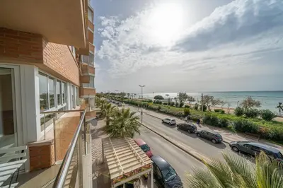 a balcony of a building with cars parked on a street at HomeHolidaysRentals Noelani- Costa Barcelona in Pineda de Mar