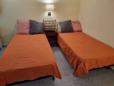two beds sitting next to each other in a room at Apart 2 beds 1 sofabed downtown 31 nigths min Barcelona in Barcelona