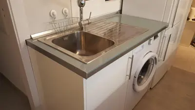 a kitchen with a sink and a washing machine at Apart 2 beds 1 sofabed downtown 31 nigths min Barcelona in Barcelona