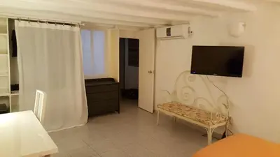 a living room with a television on a wall at Apart 2 beds 1 sofabed downtown 31 nigths min Barcelona in Barcelona