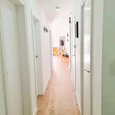 an empty hallway with white walls and wood floors at G74 AVENIDA GAUDI nice 4 bedrooms apartment with balcony with views of the Basilica Sagrada Familia in Barcelona