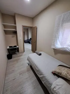 a bedroom with a bed and a piano in a room at MERIDIANA sant andreu 4 bedrooms in Barcelona
