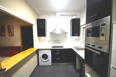 a kitchen with a microwave and a stove top oven at MERIDIANA CLOT 4 bedrooms 2 bathrooms in Barcelona
