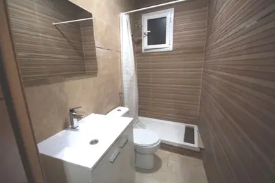a bathroom with a toilet and a sink and a tub at MERIDIANA CLOT 4 bedrooms 2 bathrooms in Barcelona