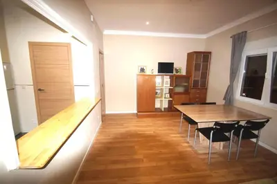 a dining room with a wooden table and chairs at MERIDIANA CLOT 4 bedrooms 2 bathrooms in Barcelona