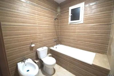 a bathroom with a toilet and a tub and a sink at MERIDIANA CLOT 4 bedrooms 2 bathrooms in Barcelona