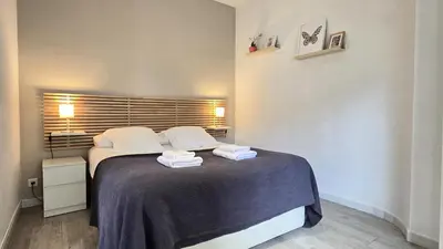 a bedroom with a bed with two towels on it at Opening Doors Gràcia in Barcelona