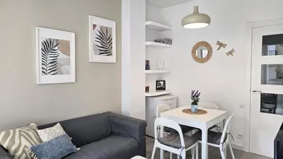 a living room with a couch and a table at Opening Doors Gràcia in Barcelona