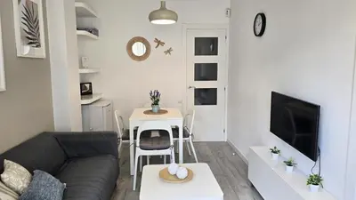 a living room with a couch and a table at Opening Doors Gràcia in Barcelona