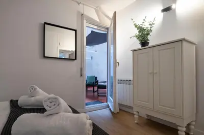 a bedroom with a mirror and a door to a room at Habitat Apartments Arenas Parc in Barcelona